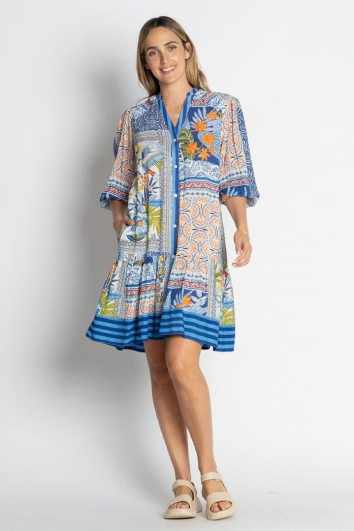 Woman wearing a colorful patterned dress on a white background