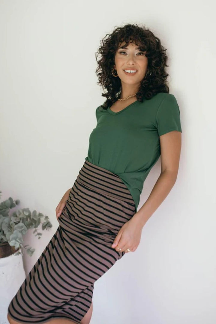 Lifestyle image of the Veronica Tee in forest green, featured at Ivy Vibe, highlighting its soft V-neckline, relaxed fit, and comfortable bamboo fabric in a casual setting.