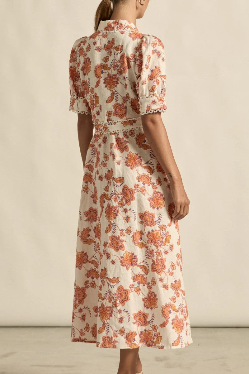 Woman wearing a floral dress with a neutral background