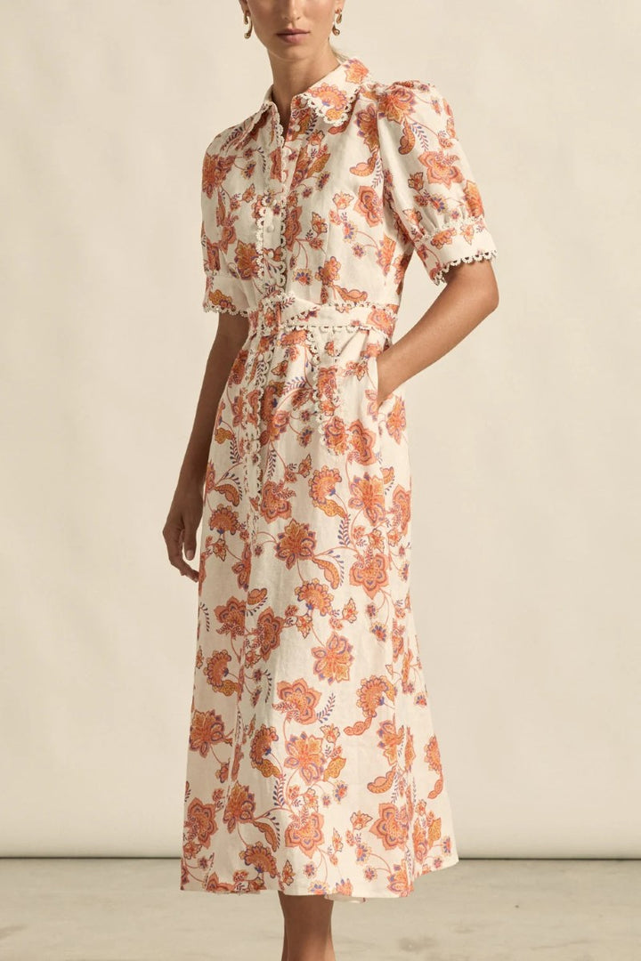 Woman wearing a floral dress with a neutral background