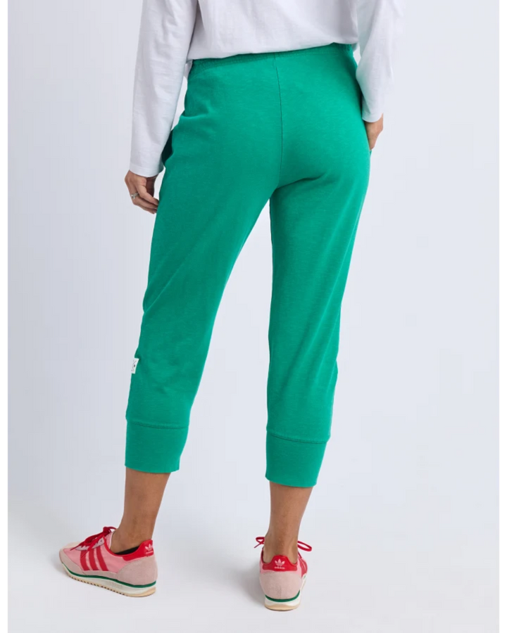 Back view of teal cropped jogger pants with elastic cuffs.