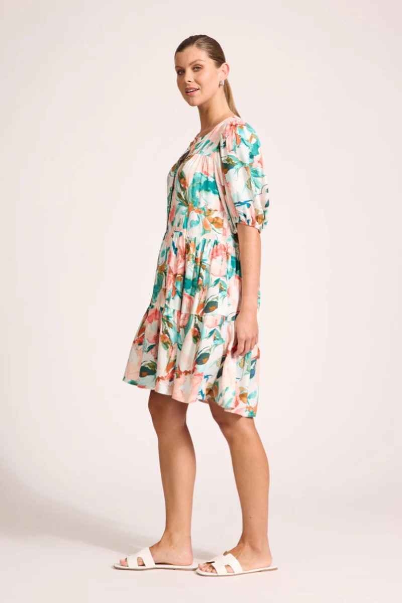 Woman wearing a floral dress on a plain background