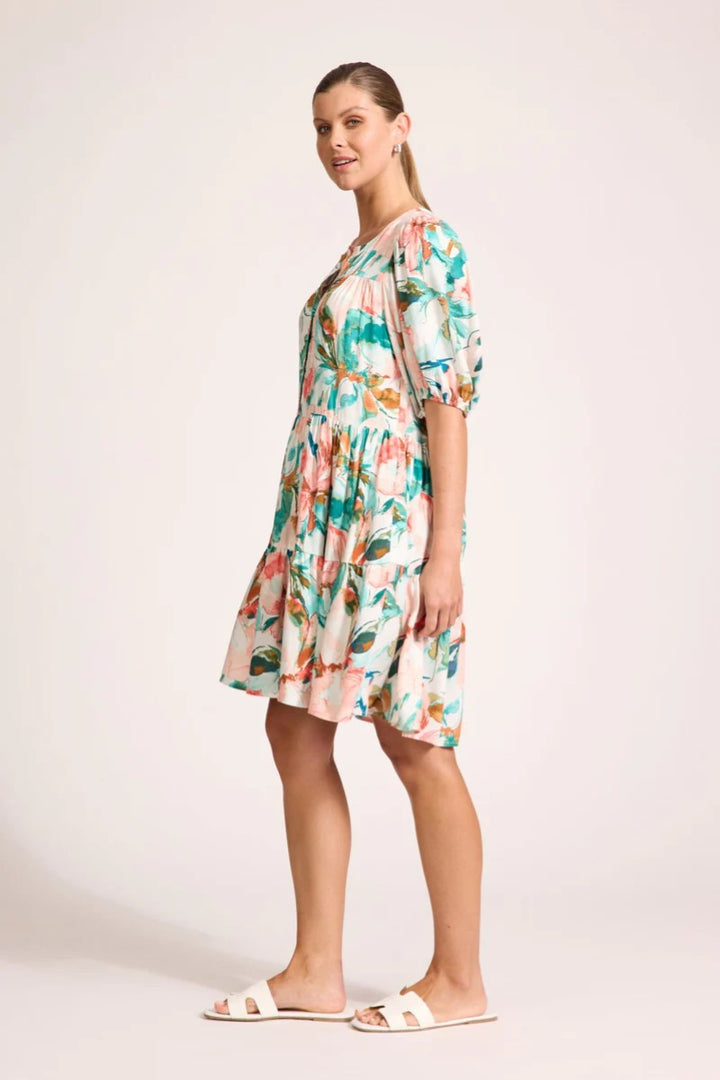 Woman wearing a floral dress on a plain background