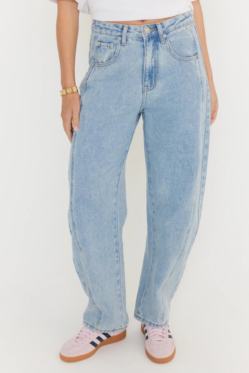 Light blue jeans worn by a person on a white background