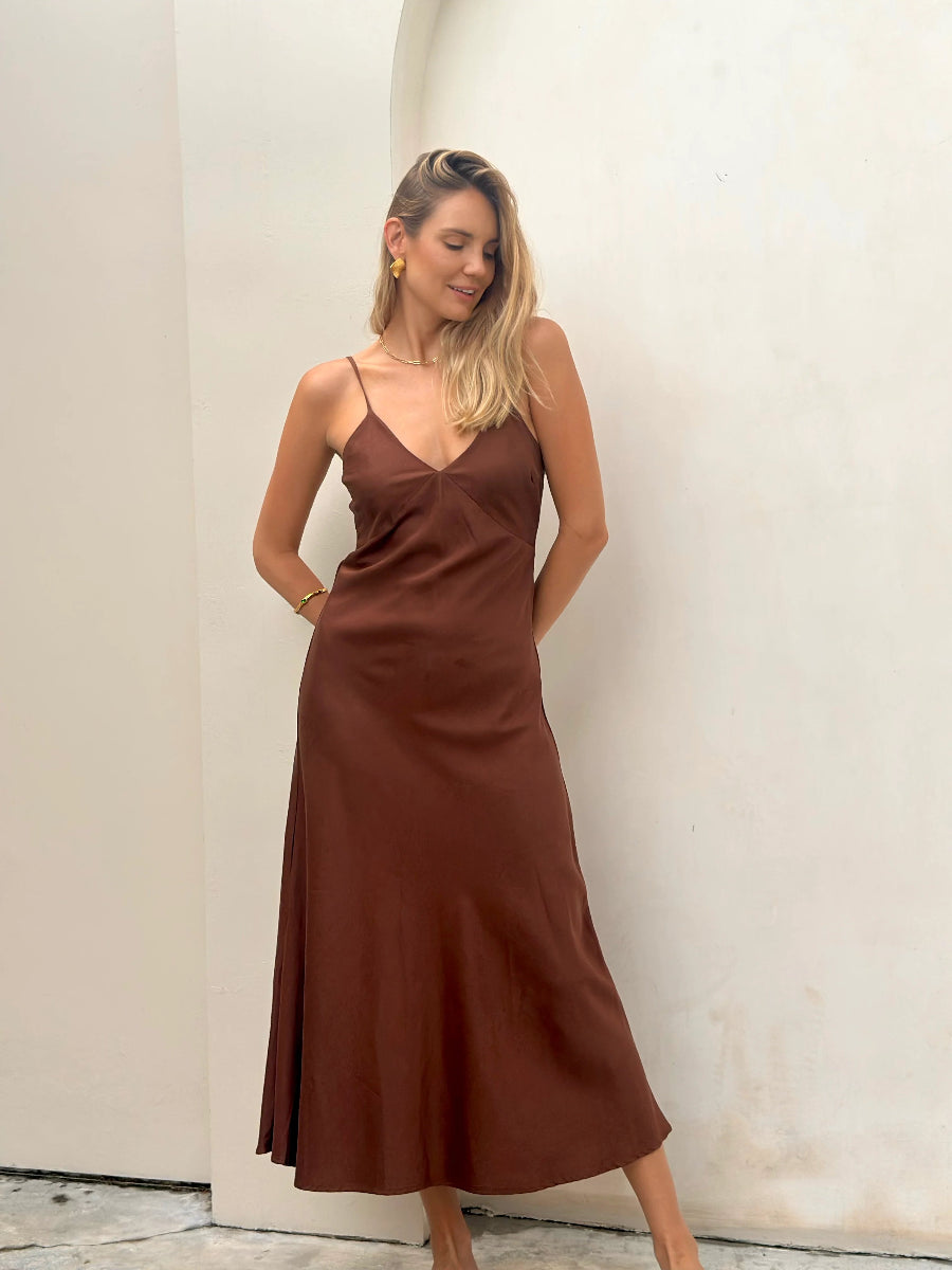 Front view of brown satin midi dress with V neckline.
