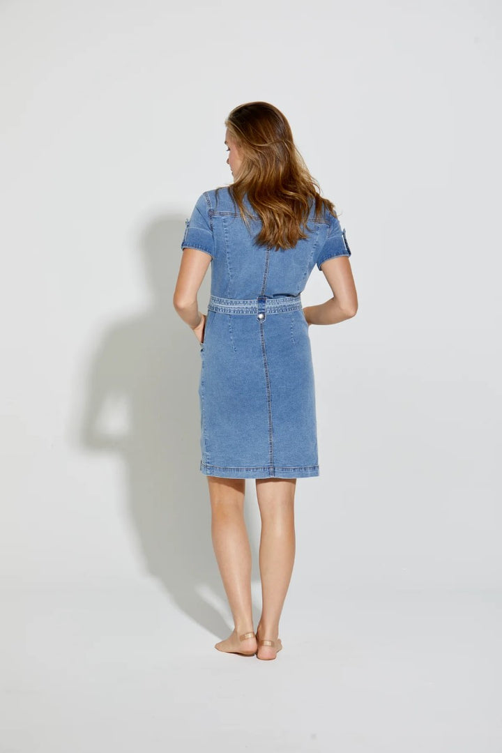 Woman wearing a blue denim dress on a white background