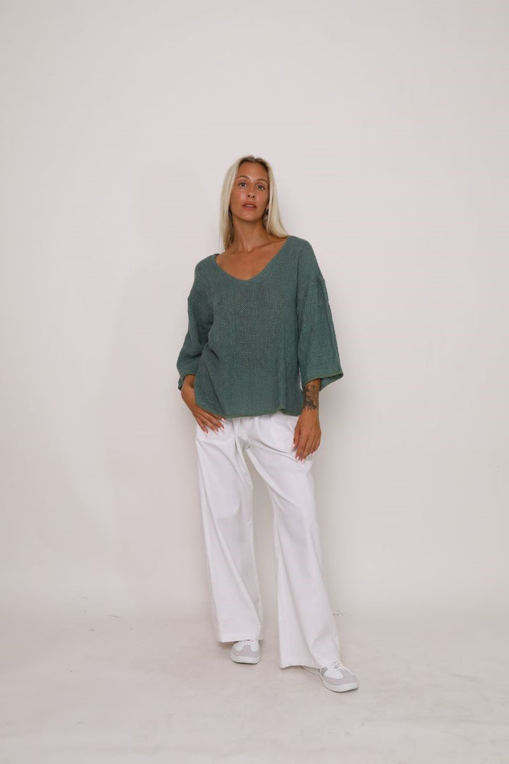 Front view of the Aroma Top in Kashmir Green, showcased at Ivy Vibe, featuring a relaxed fit, soft fabric, and stylish neckline with long sleeves.