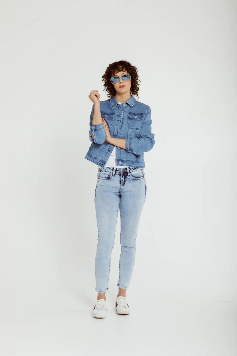 Person wearing a denim jacket and jeans on a white background