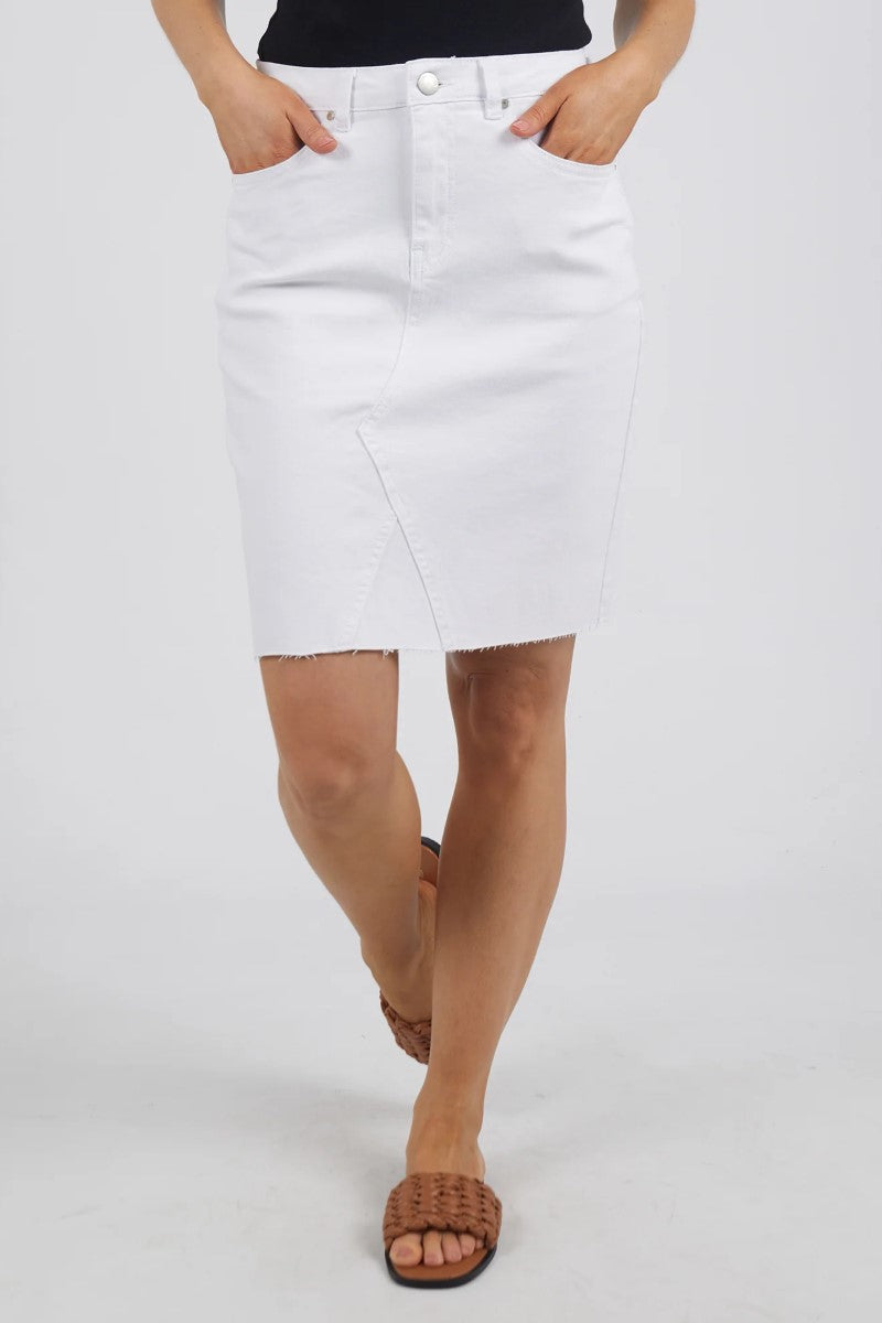 This front close-up image of the Belle Denim Skirt in Cloud Wash highlights the soft faded wash, front seam detailing, and classic waistband with button and zip closure.
