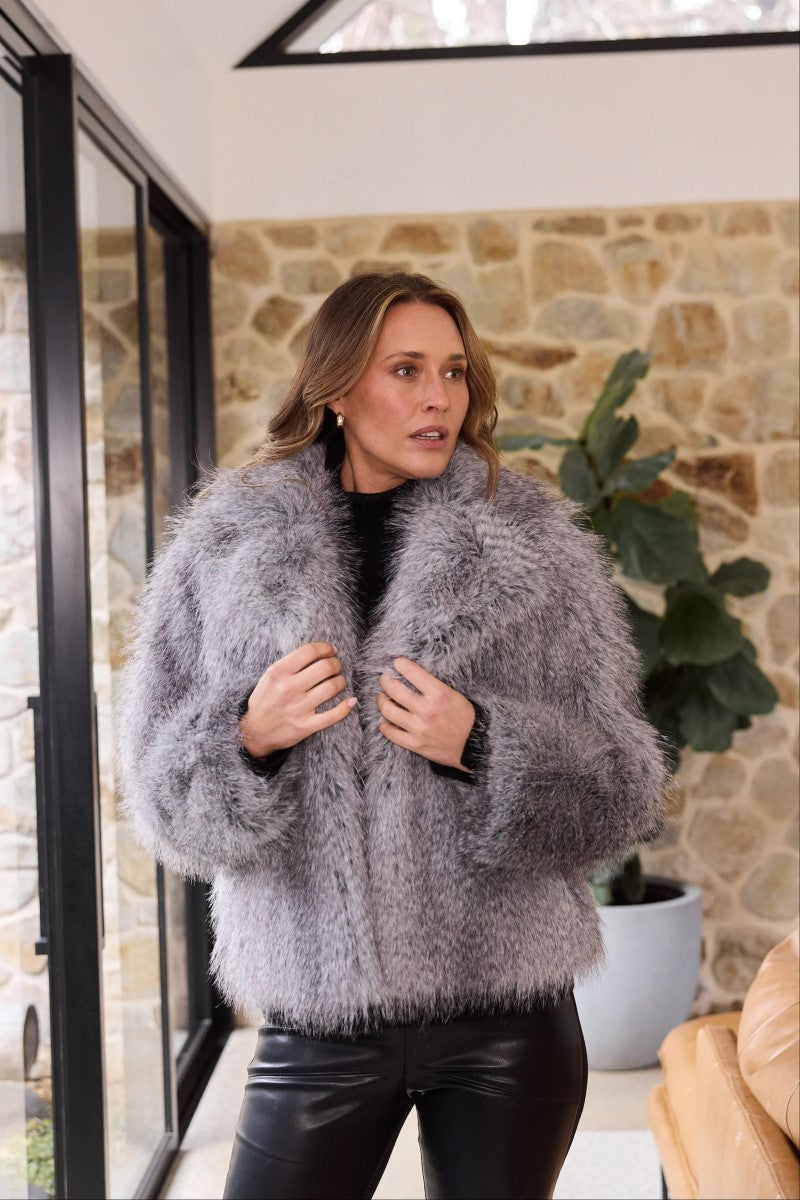 Lifestyle image of the Bertoli Jacket in Grey Speckle, styled with a high neck, long sleeves, and zip-front closure for a casual, cozy look