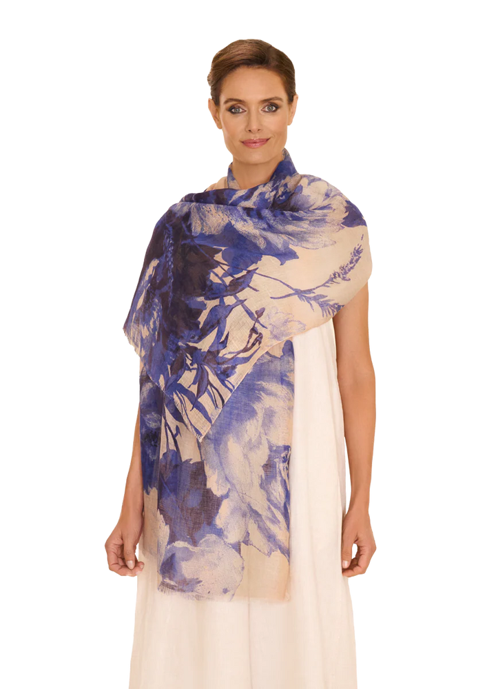Woman wearing a blue and white patterned scarf on a white background
