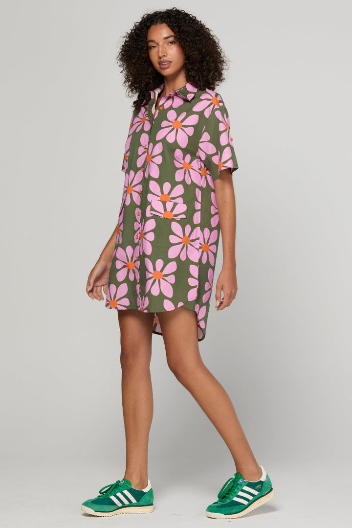 Woman wearing a floral dress with green background