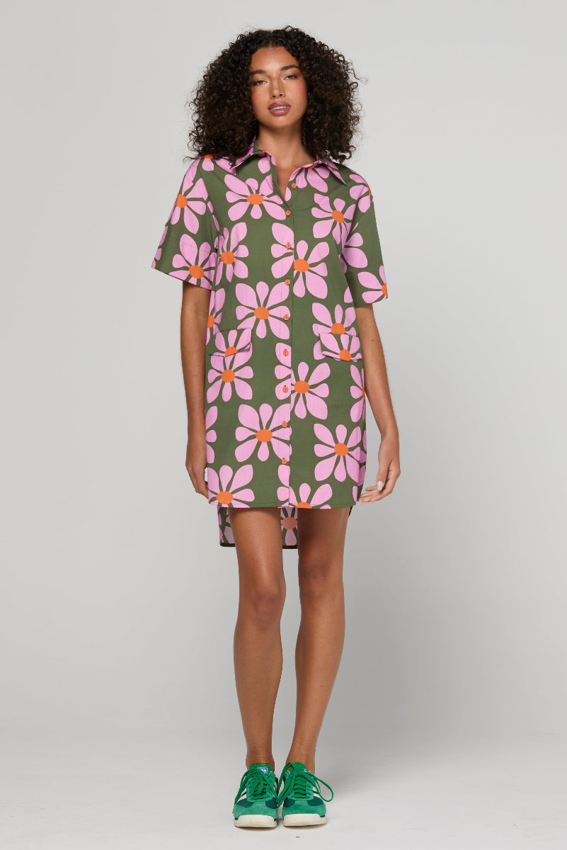 Woman wearing a floral dress with a plain background
