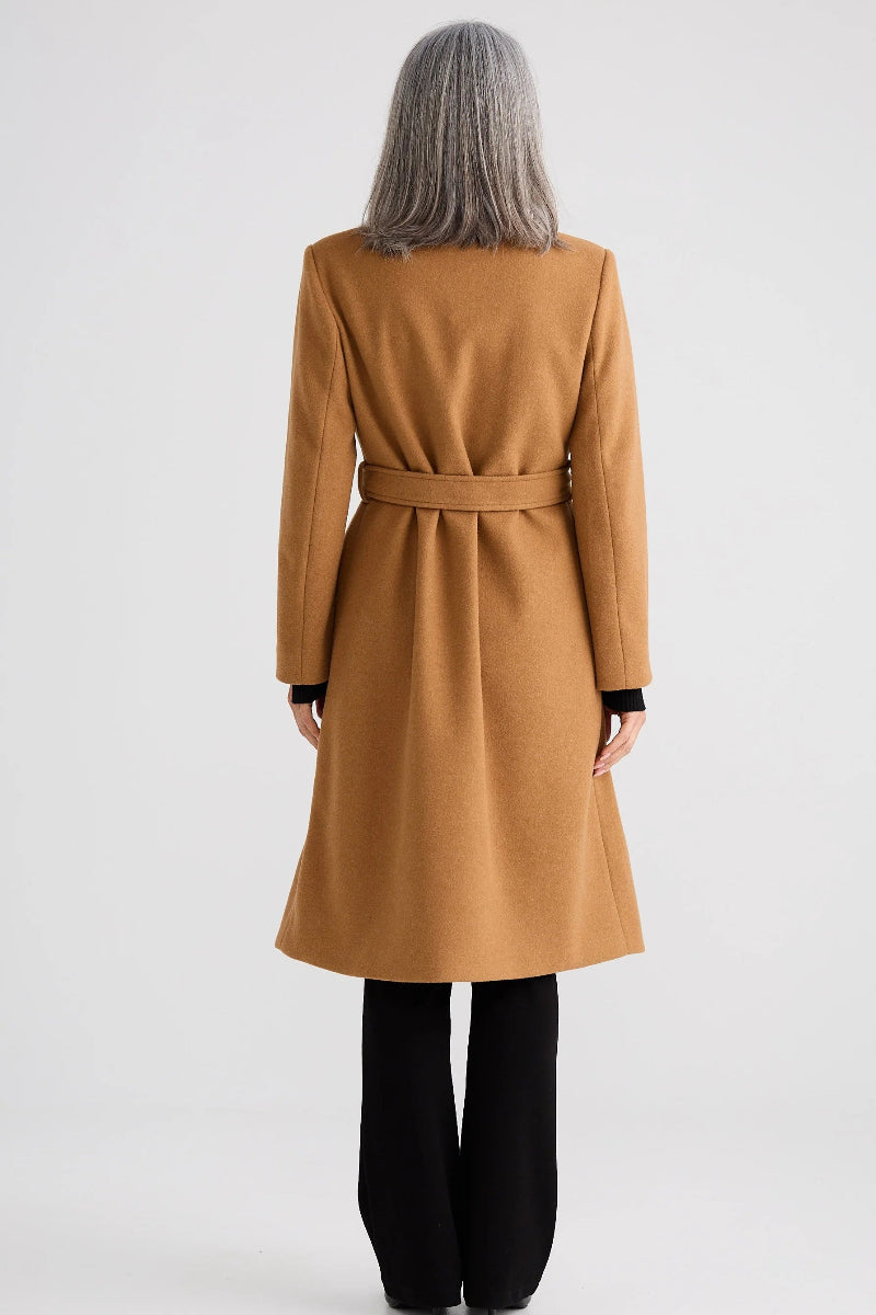 Person wearing a long brown coat on a white background