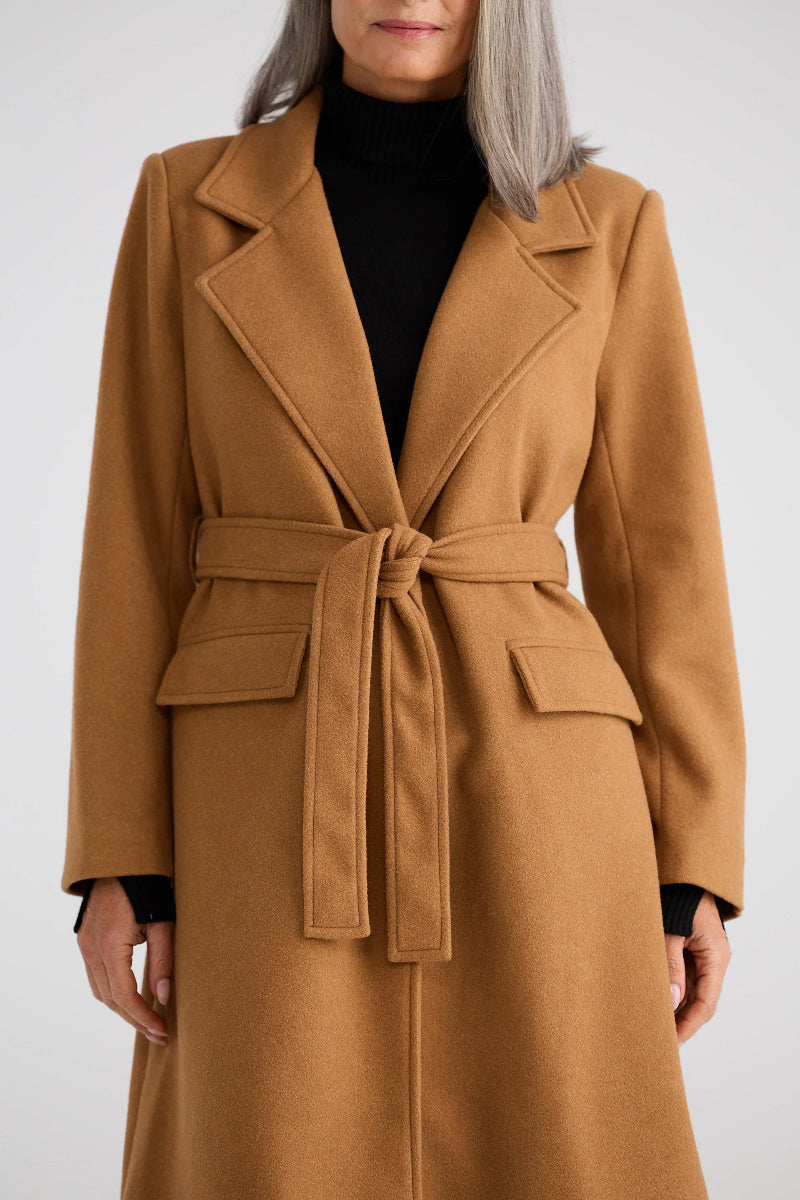 Brown coat worn by a person on a white background