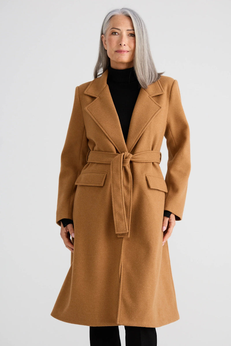 Woman wearing a brown coat on a white background