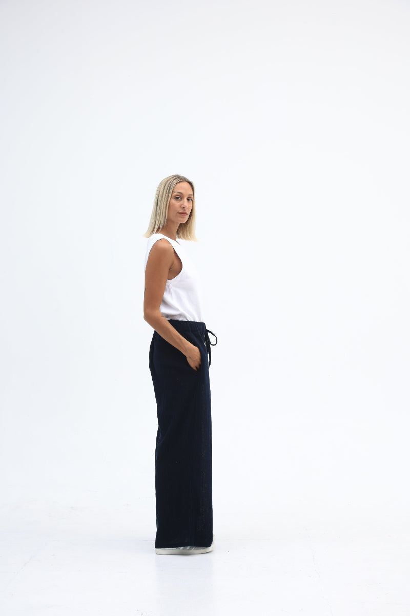 Person lying on a white background with a black yoga mat
