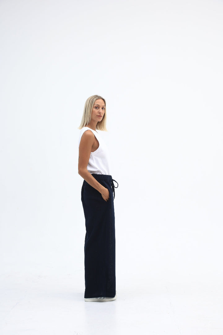 Person lying on a white background with a black yoga mat