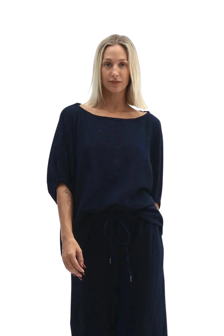 Woman wearing a navy blue dress on a white background