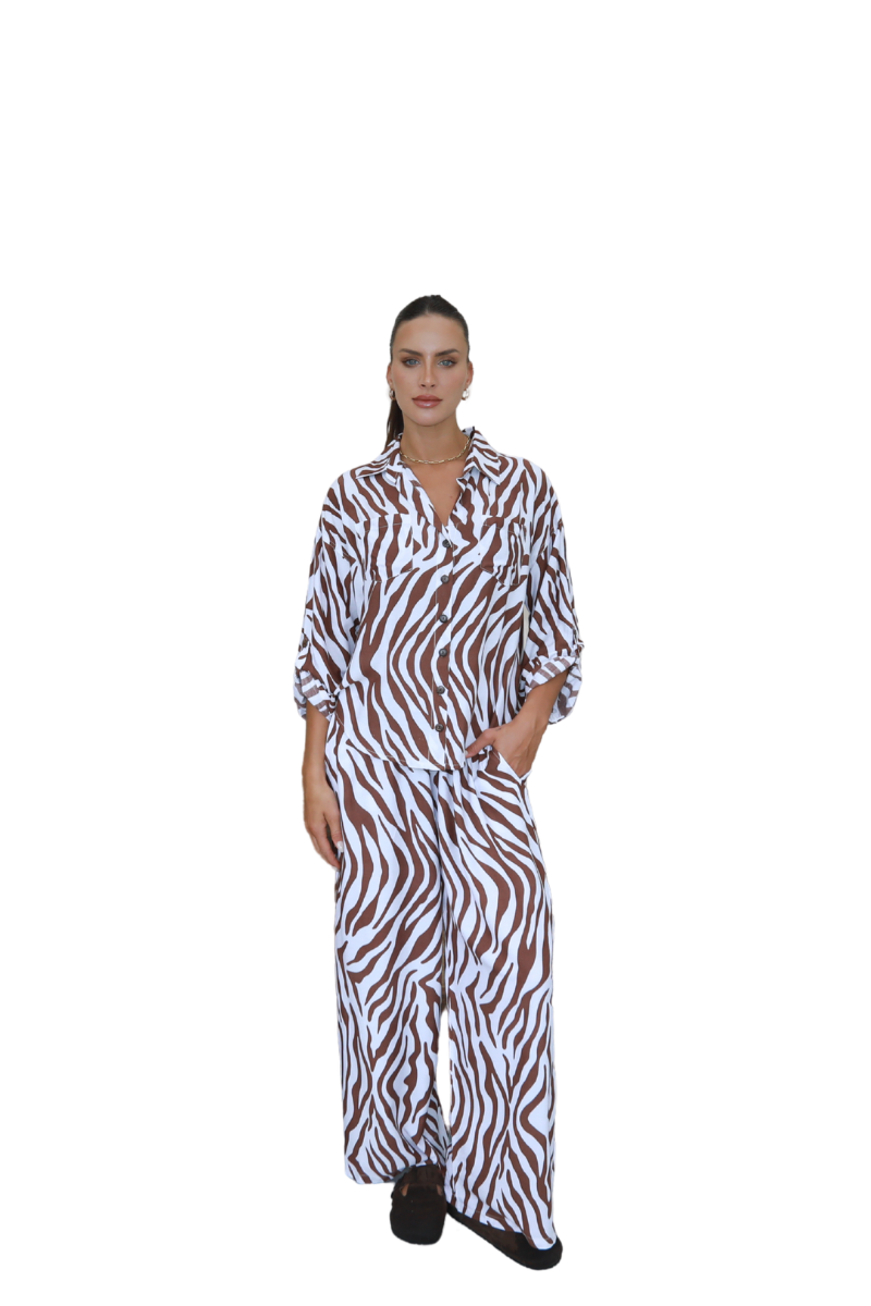 Woman wearing a zebra print dress on a white background