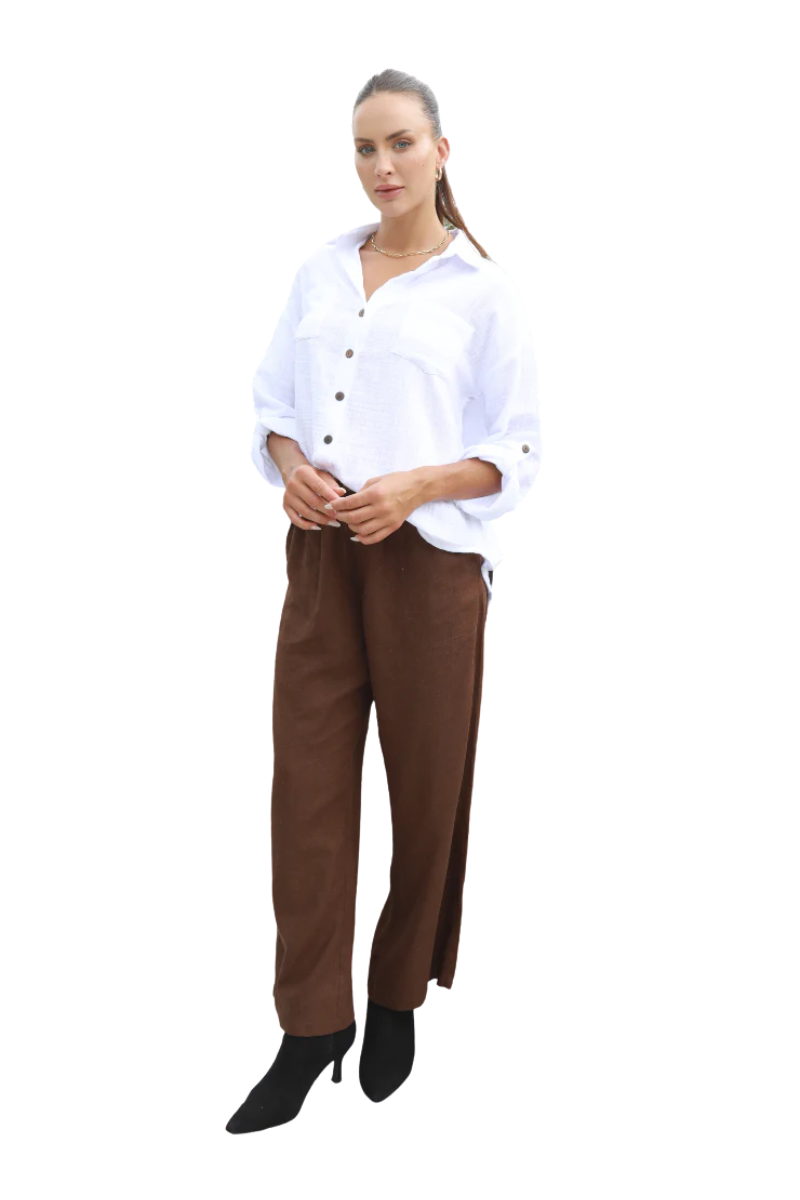 Woman wearing a white shirt and brown pants on a white background