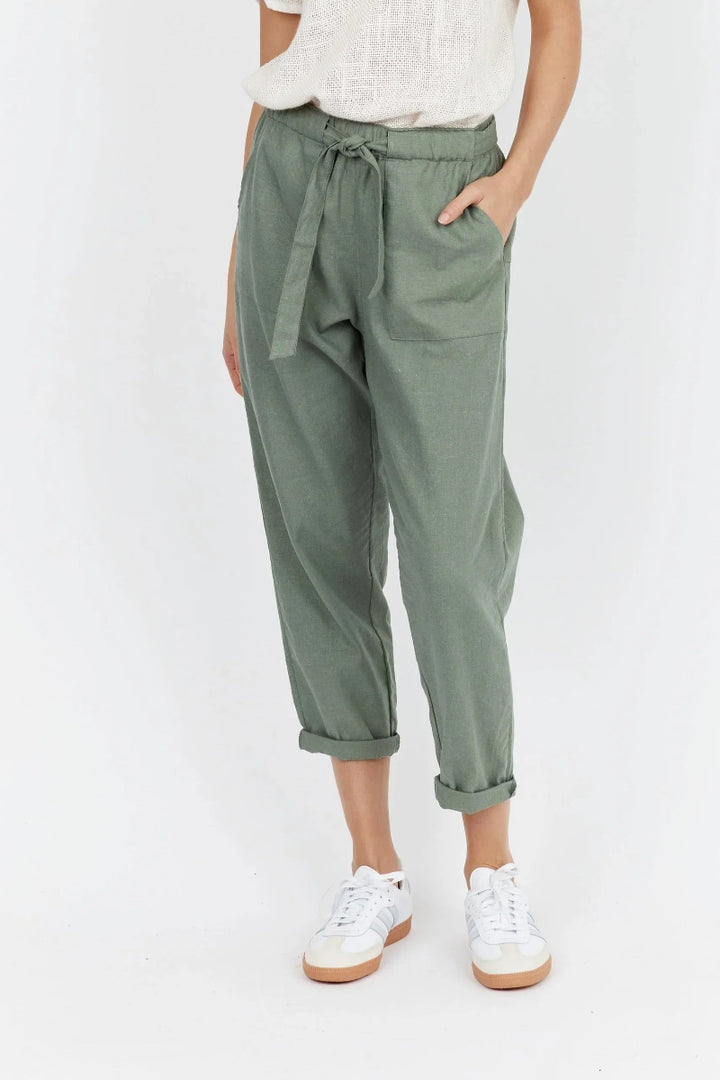 Person wearing green pants with a tie waist on a white background