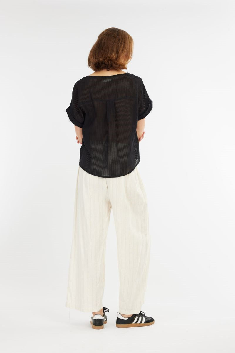 Back view of the Carmen Striped Top in black from Ivy Vibe, showing the relaxed fit, curved hem, and lightweight cotton fabric with a textured stripe pattern.