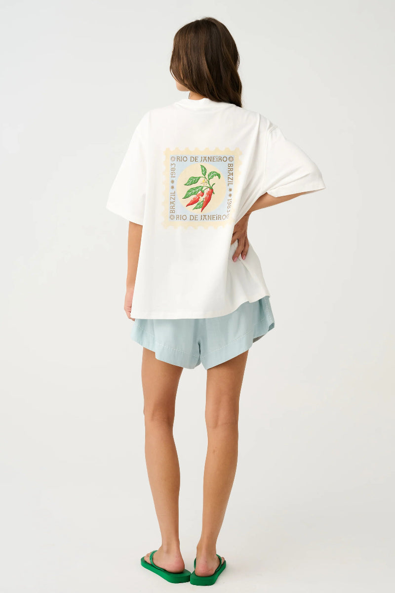 Back view of white oversized graphic T-shirt with chili stamp print.