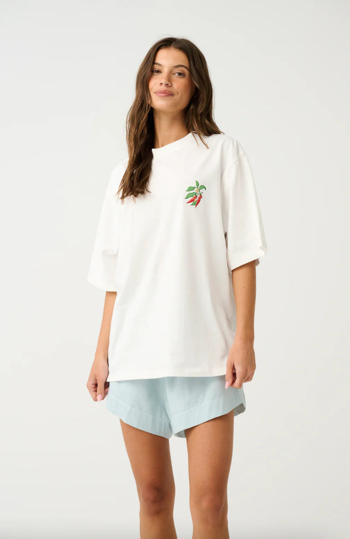 Front view of white oversized short-sleeve T-shirt with small chili graphic.