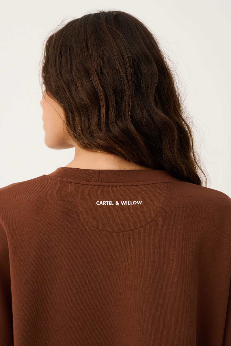 Brown sweatshirt with 'Carfel & Willow' logo on a plain background