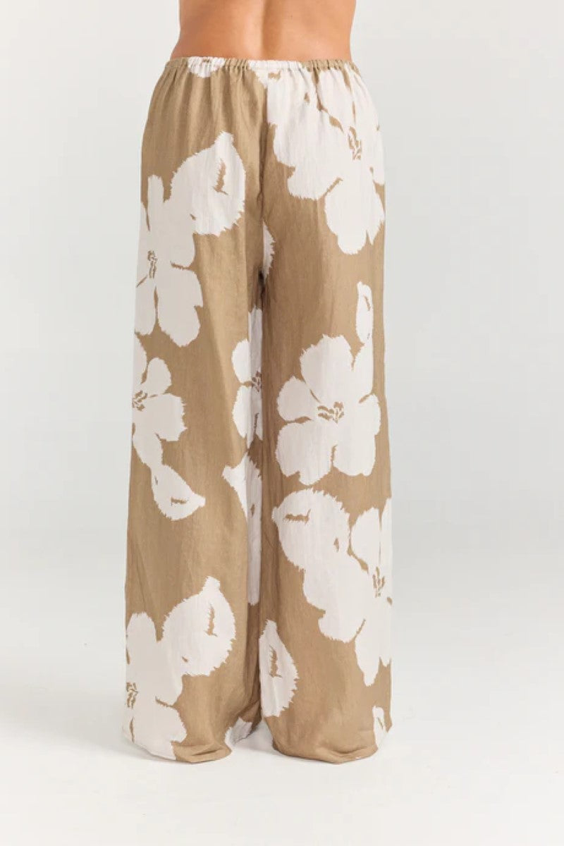 Floral pants with white flowers on a beige background
