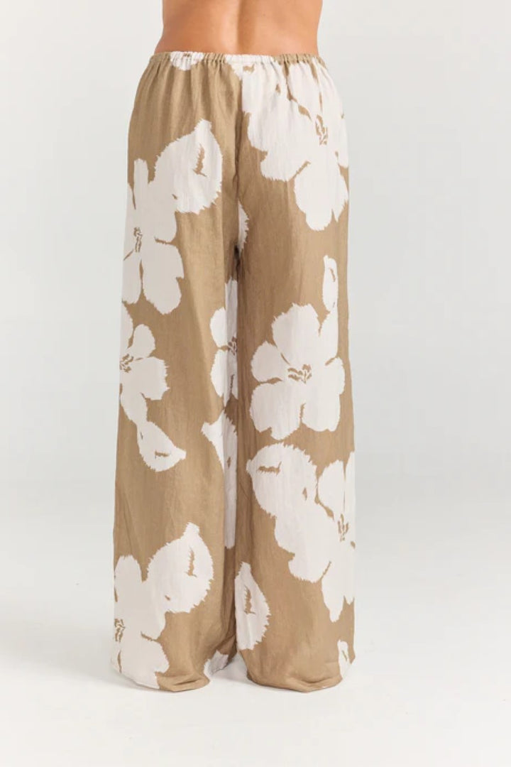 Floral pants with white flowers on a beige background