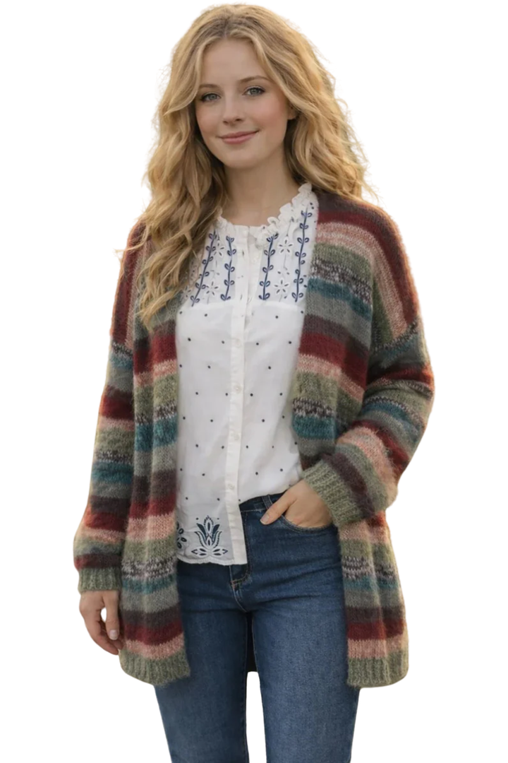 Woman wearing a colorful striped cardigan over a white blouse with blue patterns.