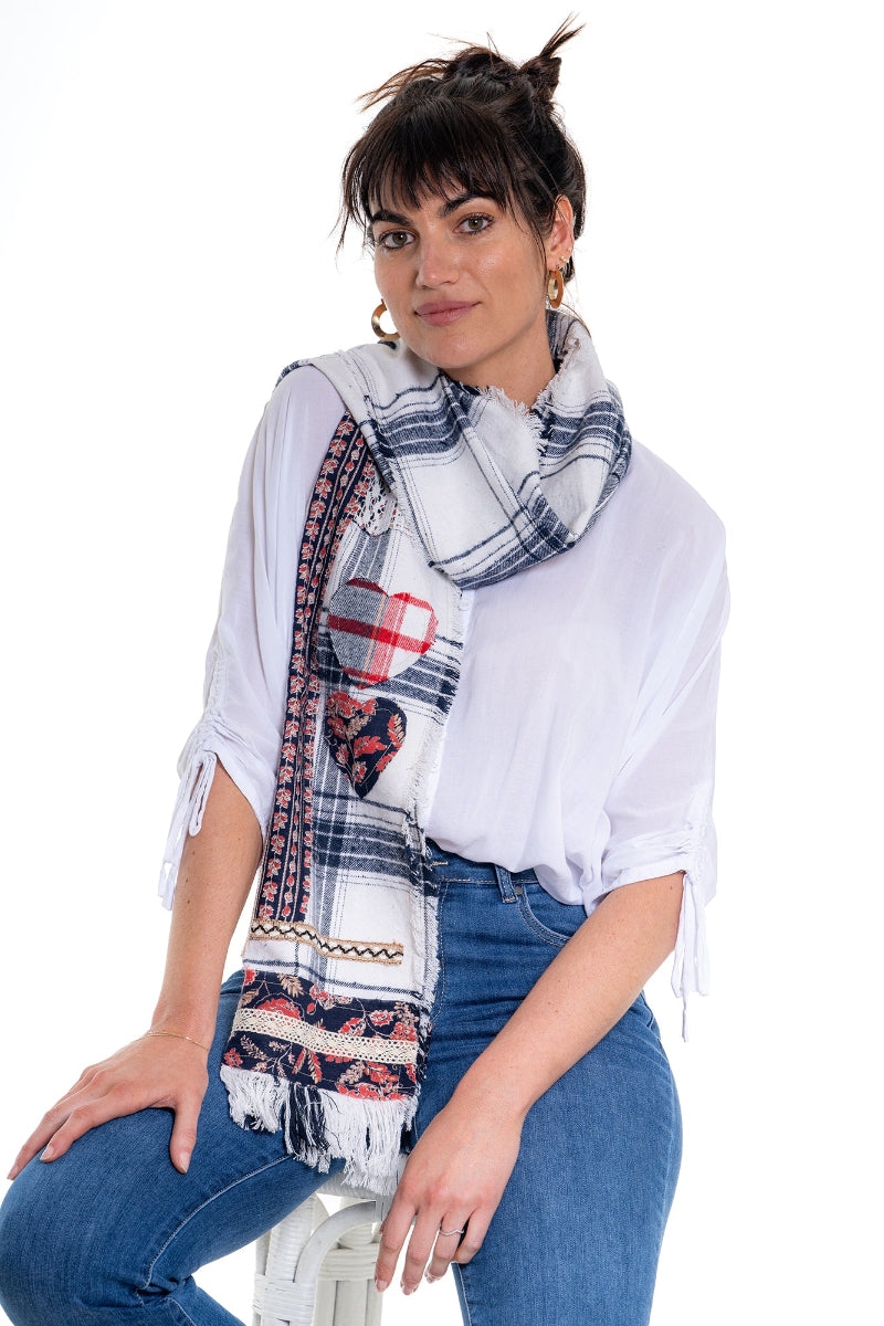 Woman wearing a colorful scarf with patterns and text on a white background
