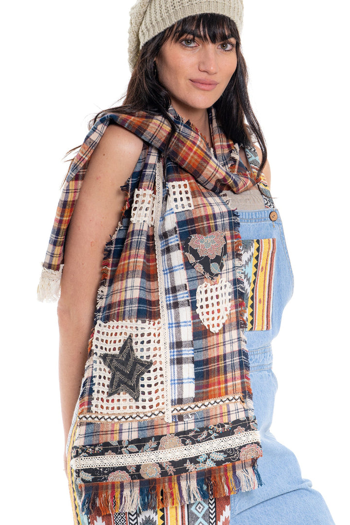 Woman wearing a plaid scarf with star patterns on a white background