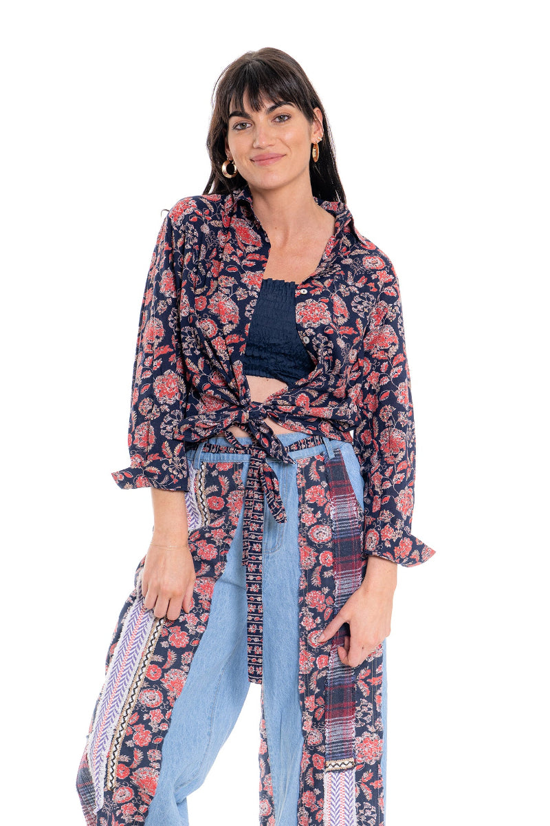 Woman wearing a floral patterned outfit on a white background