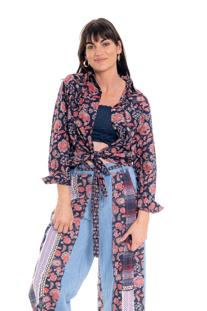 Woman wearing a floral patterned outfit on a white background