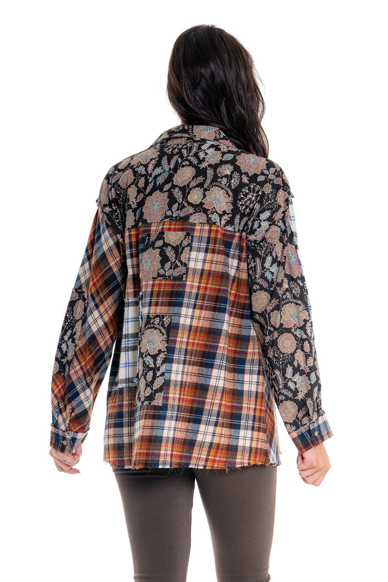 Flannel shirt with floral pattern over plaid design on a white background