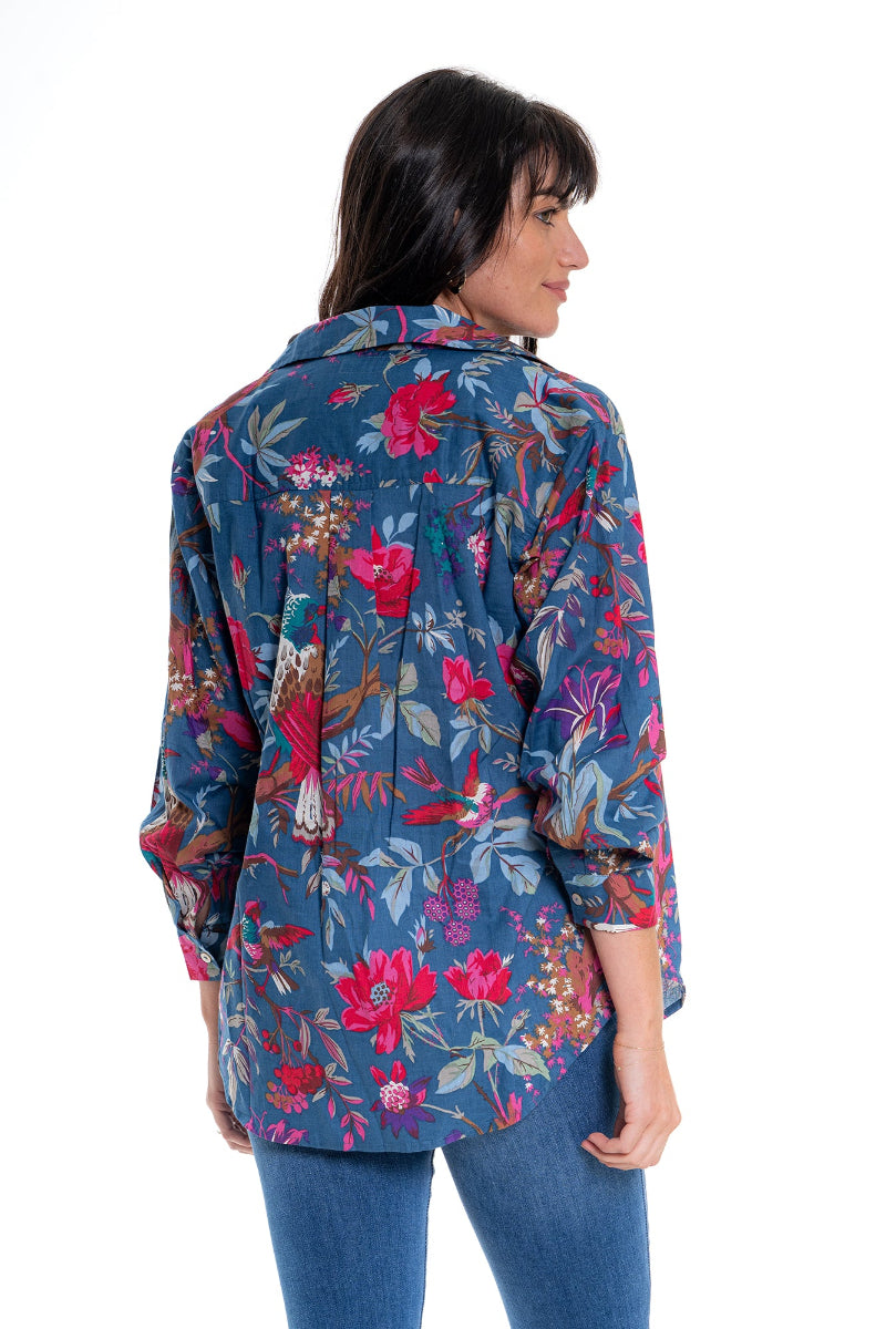 Woman wearing a colorful floral jacket on a white background
