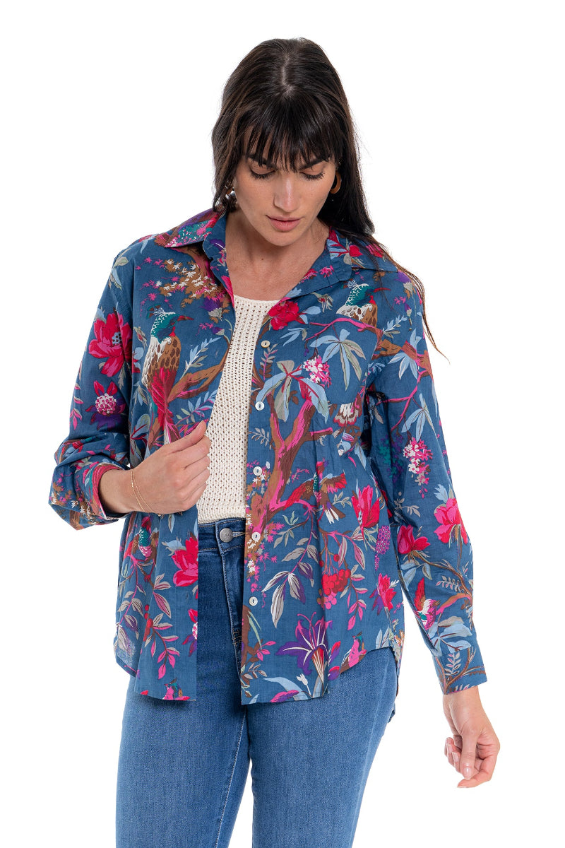 Woman wearing a colorful floral jacket on a white background