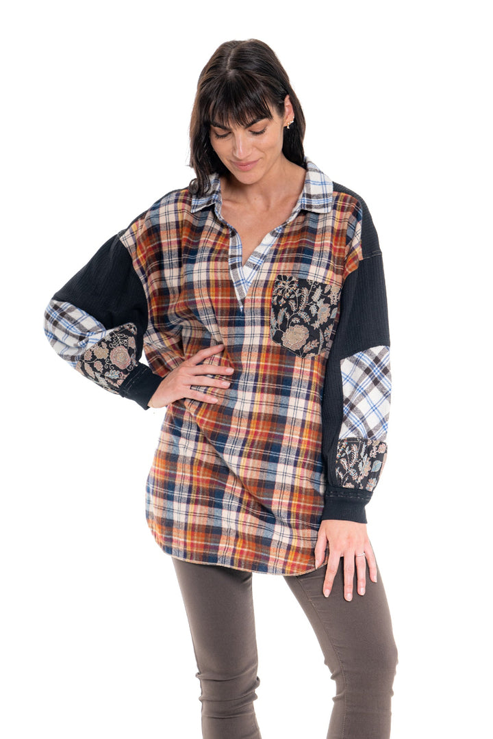 Woman wearing a plaid shirt with patterned sleeves on a white background