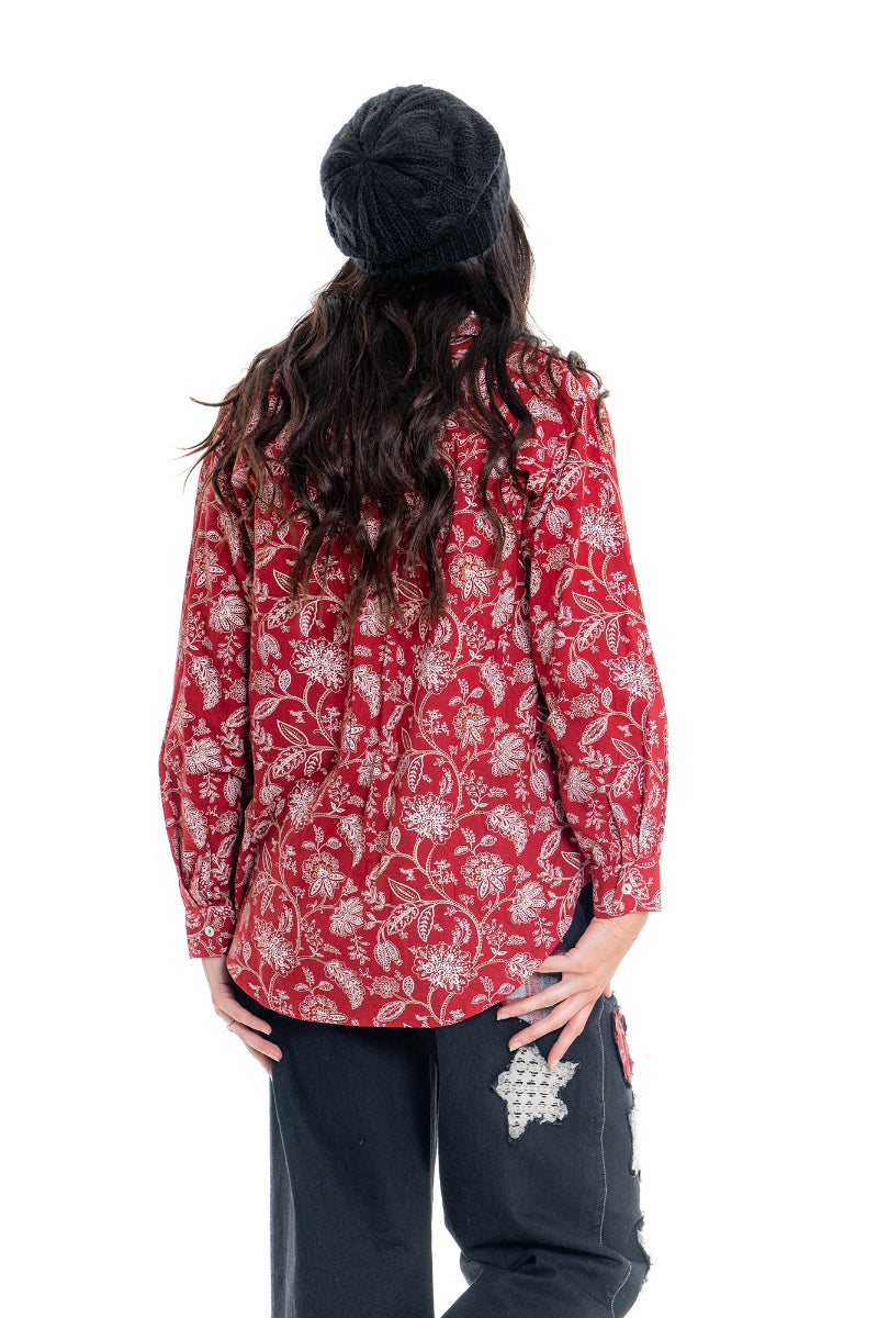 Person wearing a red floral patterned jacket on a white background