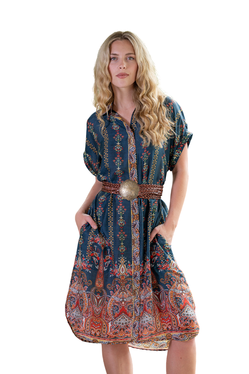 Woman wearing a patterned dress with a belt on a white background