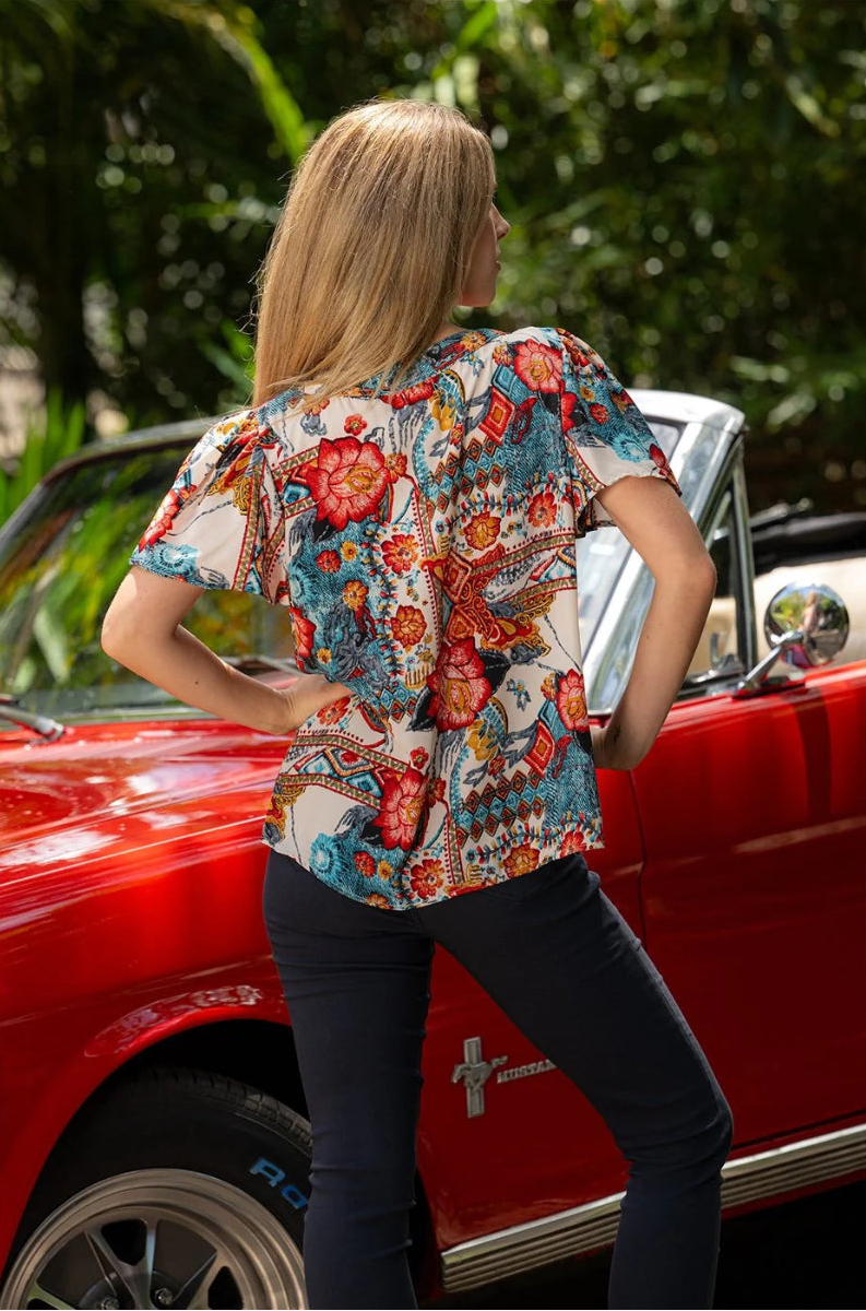 Back view of woman in patterned blouse.