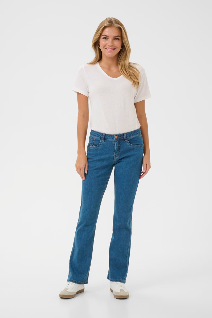 Woman wearing a white t-shirt and blue jeans on a white background