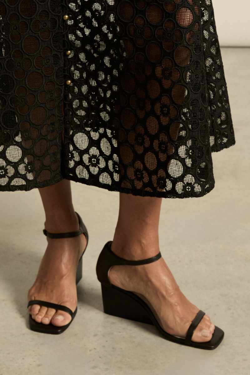 Model wearing the Delight Wedge in Black, featuring a sleek design and comfortable fit for versatile styling