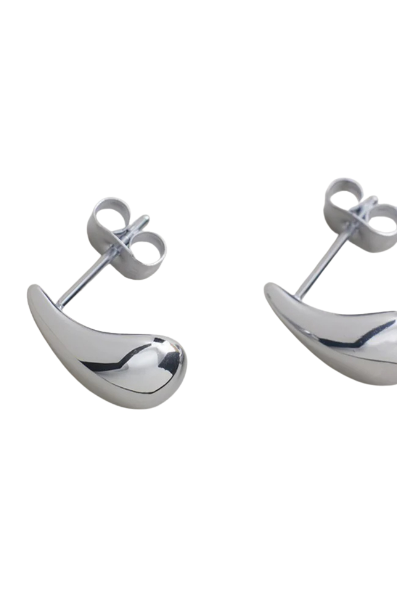 The Dolly Earrings in Silver by Zahar feature a classic dome-shaped design with a smooth, polished finish, offering timeless elegance and everyday style — available at Ivy Vibe.
