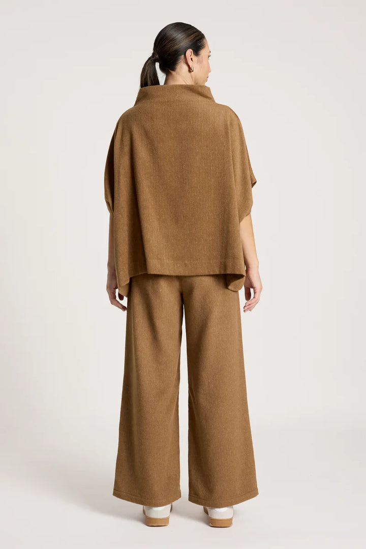 woman wearing Azul Poncho in Clay