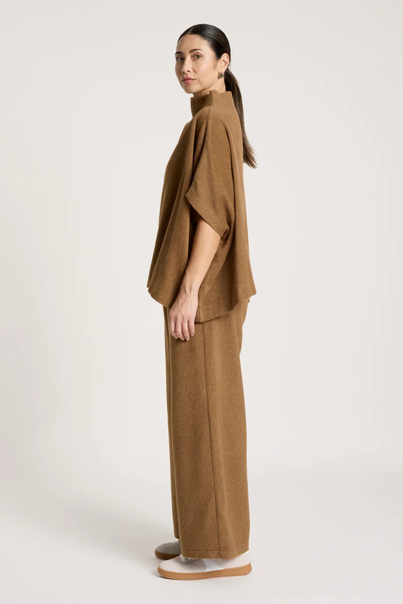 woman wearing Azul Poncho in Clay