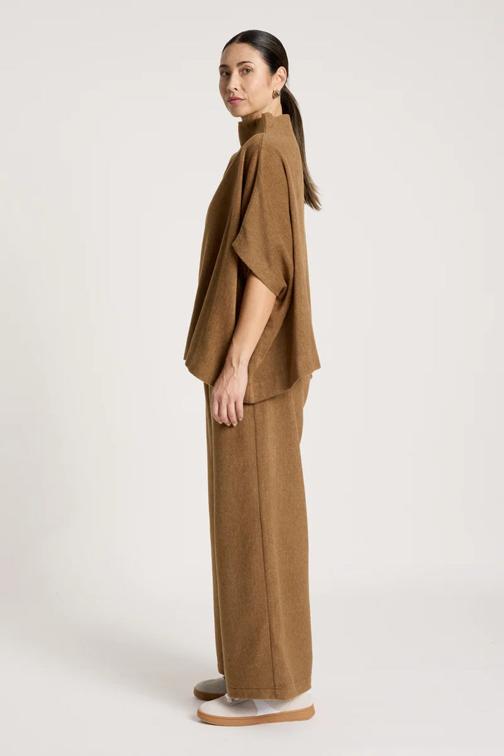woman wearing Azul Poncho in Clay